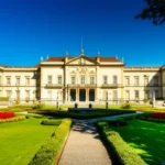 Museu Imperial de Petrópolis com jardim, sob luz dourada.